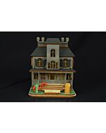 The Ginger Cottages Haunted Mansion ornament is a finely crafted wooden piece, hand-assembled with intricate details inside and out. Designed to glow when lit from within, it reveals hidden surprises that bring spooky magic to any Halloween display.
