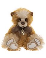 Charlie Bears Zsa Zsa plush bear in rich pink and burgundy tones, featuring long, wavy fur and a satin ribbon tied in a bow at the neck.